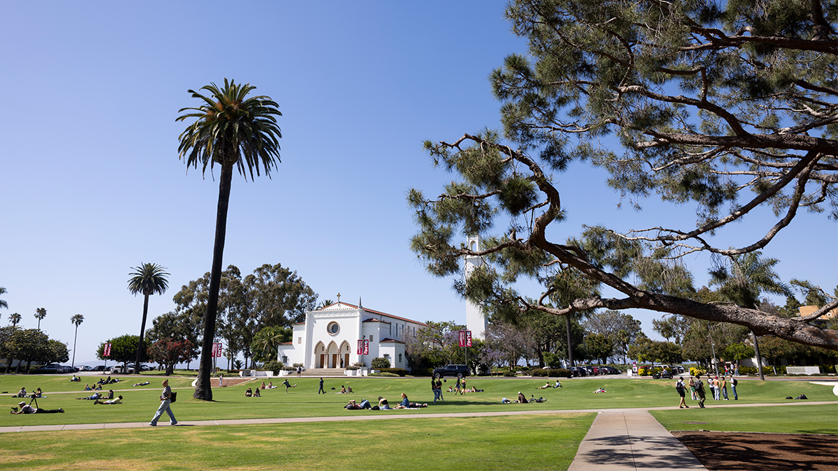LMU campus with chapel and students walking across grass